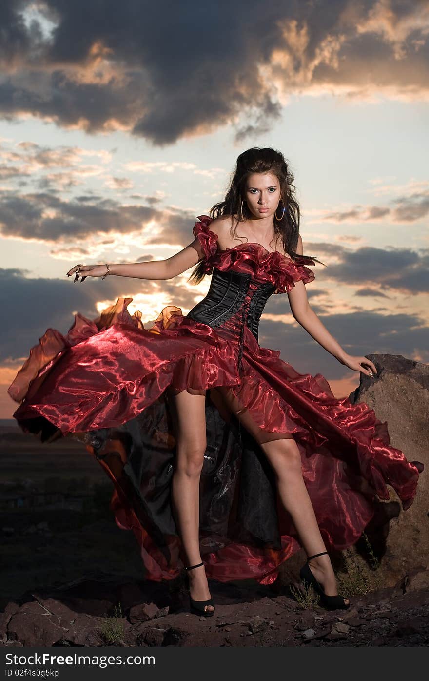 The beautiful girl in a long red dress