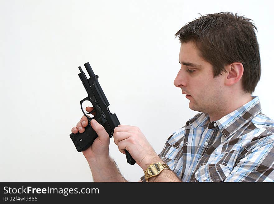 A man chambering a round in his semi auto pistol. A man chambering a round in his semi auto pistol