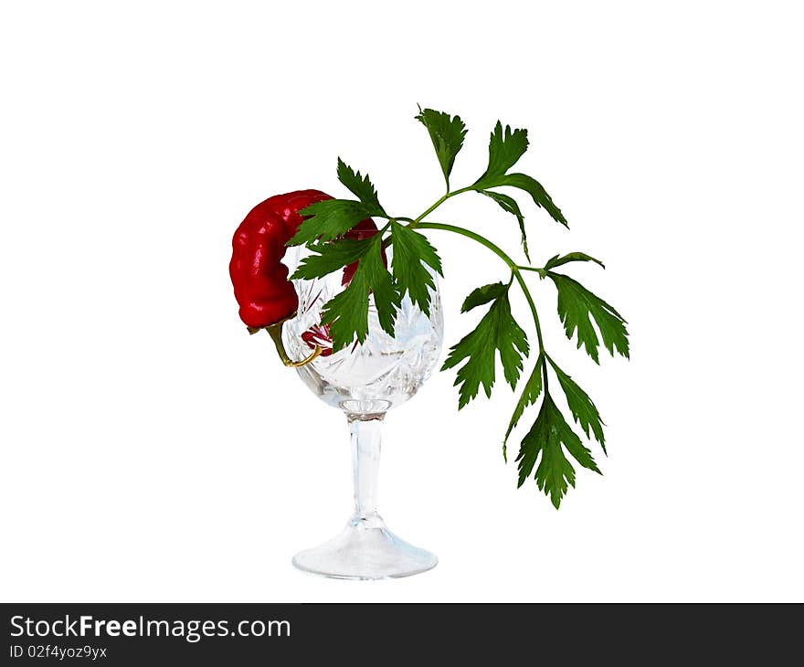 Still-life a crystal glass, pepper and parsley on a white background close up is isolated