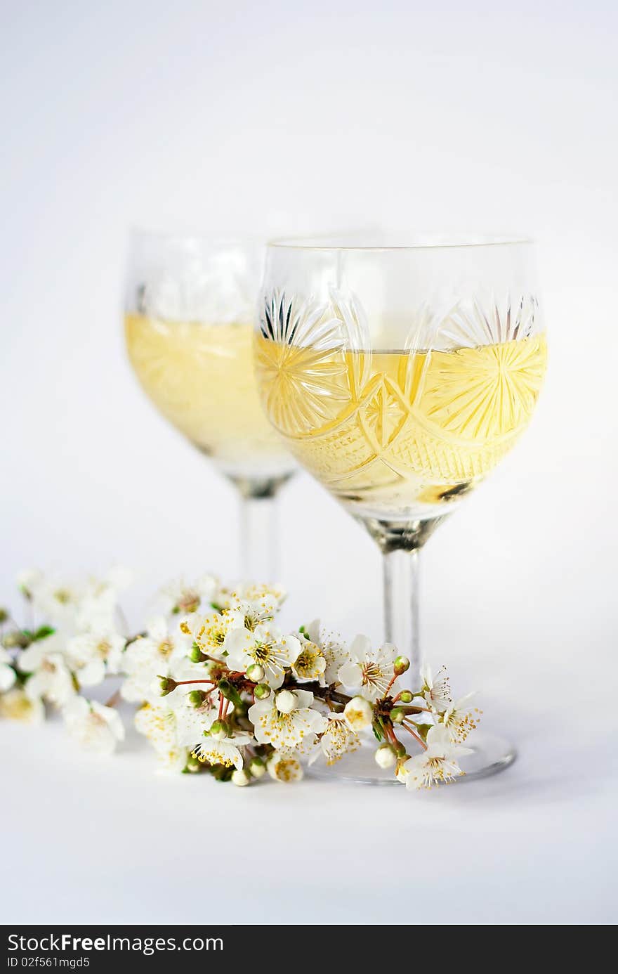 Romantic wine glasses with white wine and plums branch. Romantic wine glasses with white wine and plums branch