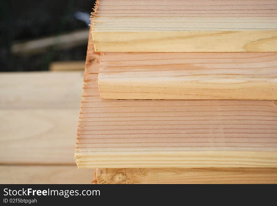 Close up of the end of a stack of cut wooden boards, Horizontal shot. Close up of the end of a stack of cut wooden boards, Horizontal shot.