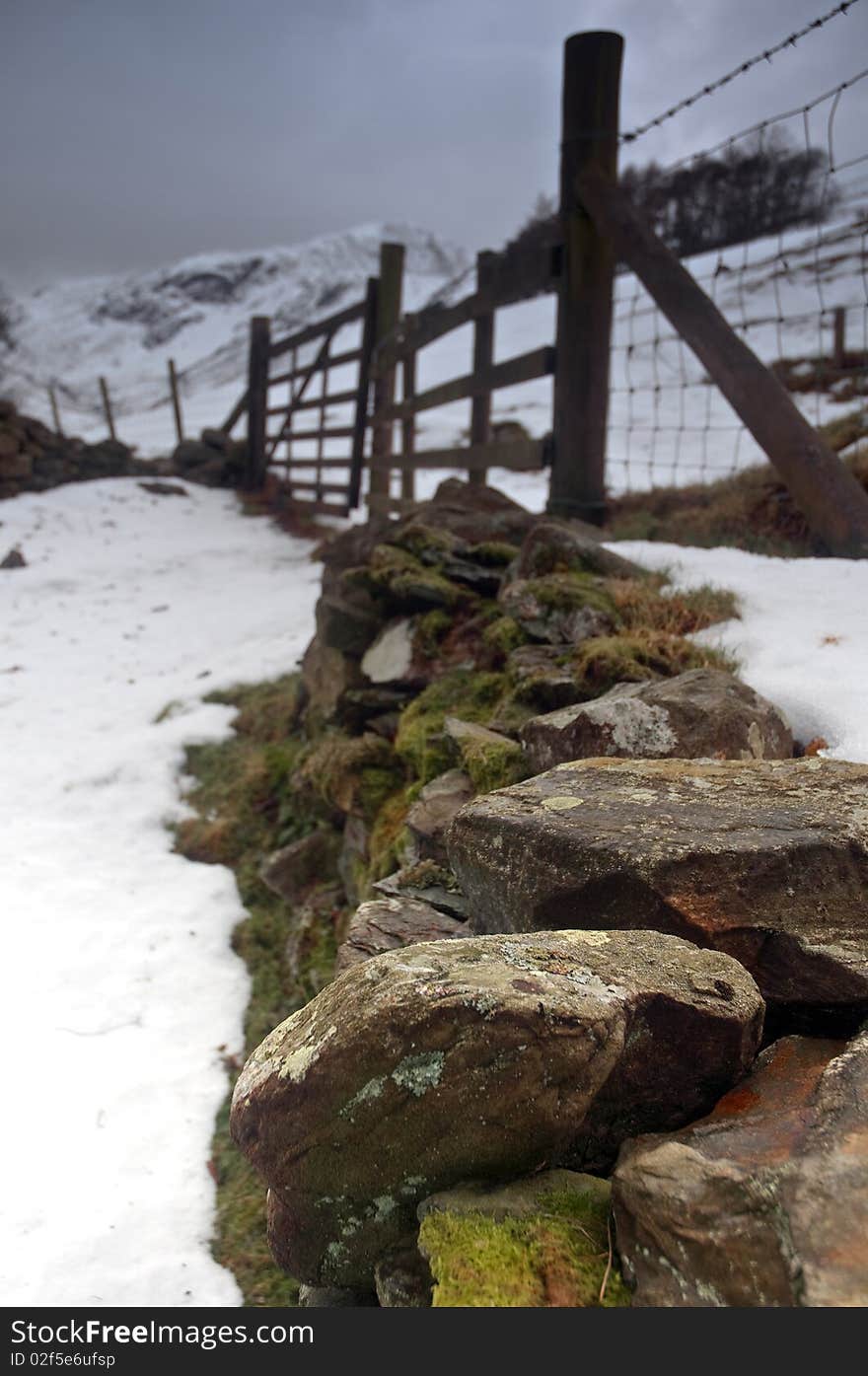 A traditional stone wall and fence in a wintery Lake District, Cumbria