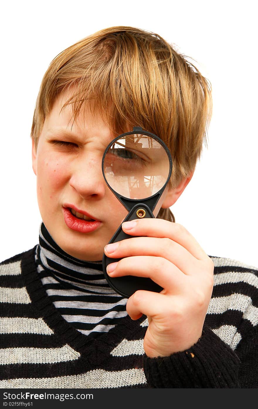 A boy looking through a magnifying glass on a white background. A boy looking through a magnifying glass on a white background