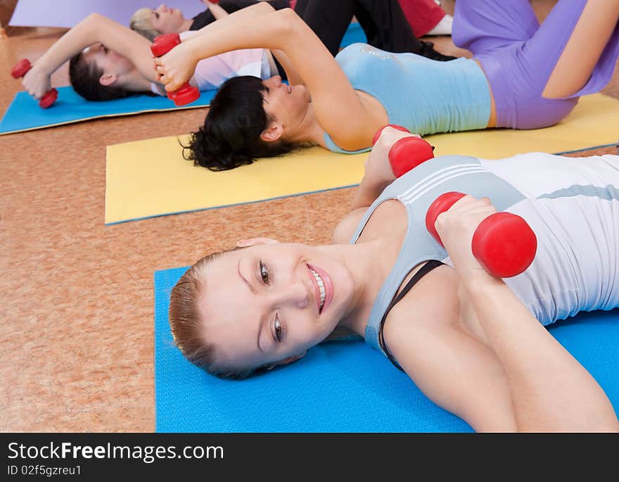 Young women exercising with dumbbells