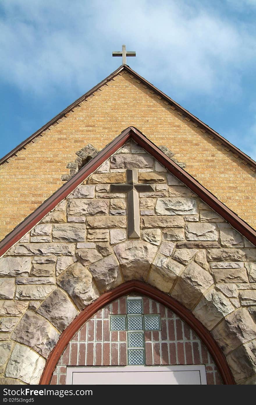 Three crosses in a row on the front of a church. Three crosses in a row on the front of a church