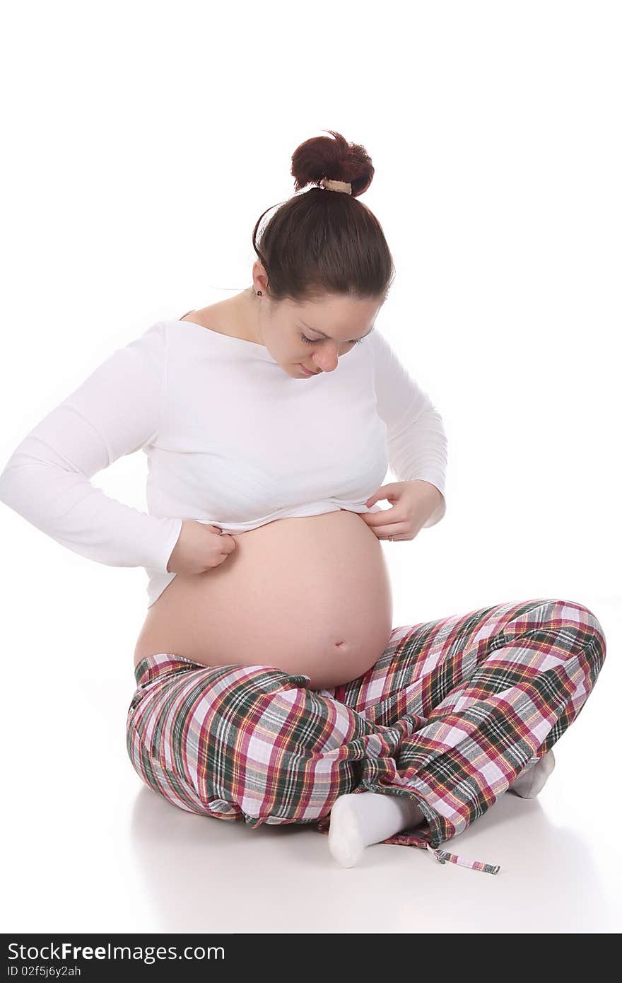 Pregnant woman looking belly on white background