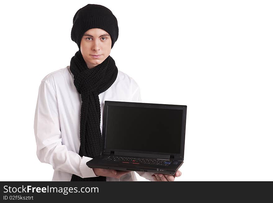 Teenager with a knitted cap and scarf, holding a laptop. Teenager with a knitted cap and scarf, holding a laptop.