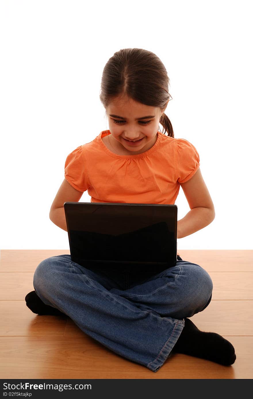 Young child looking happy using laptop computer. Young child looking happy using laptop computer