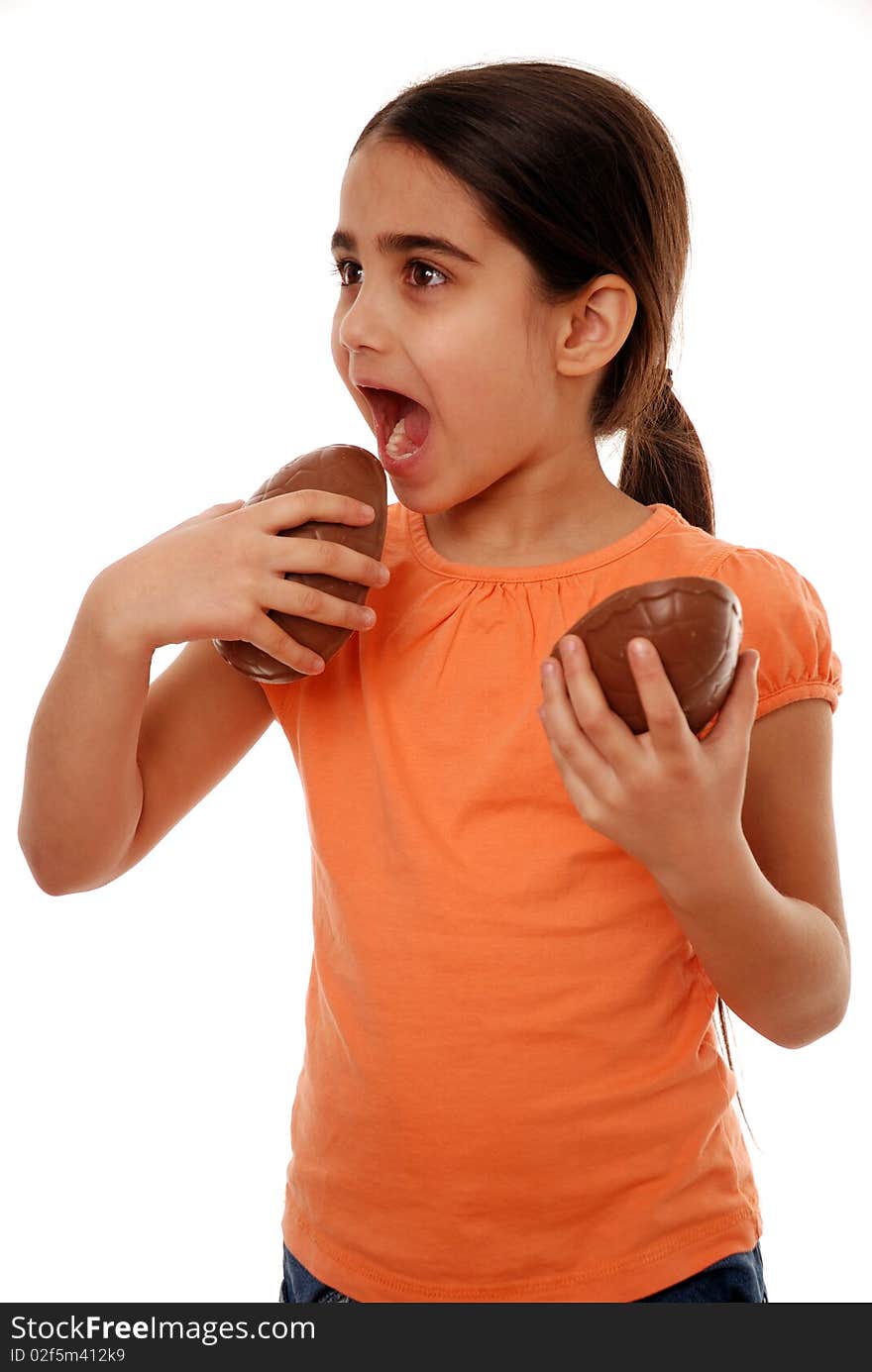 Girl eating Easter egg treat isolated on white