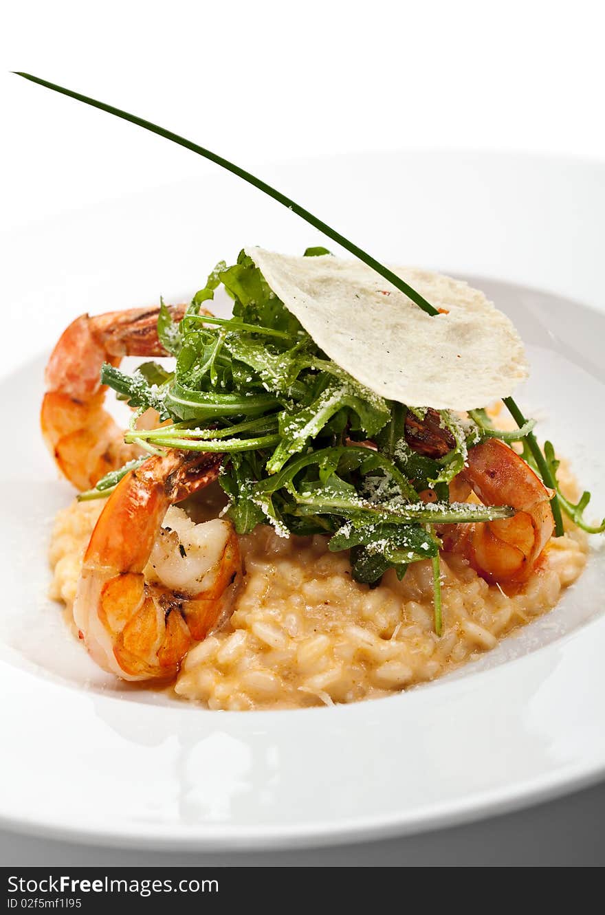 Risotto with Tiger Prawns and Rucola. Served with Parmesan Chip. Risotto with Tiger Prawns and Rucola. Served with Parmesan Chip