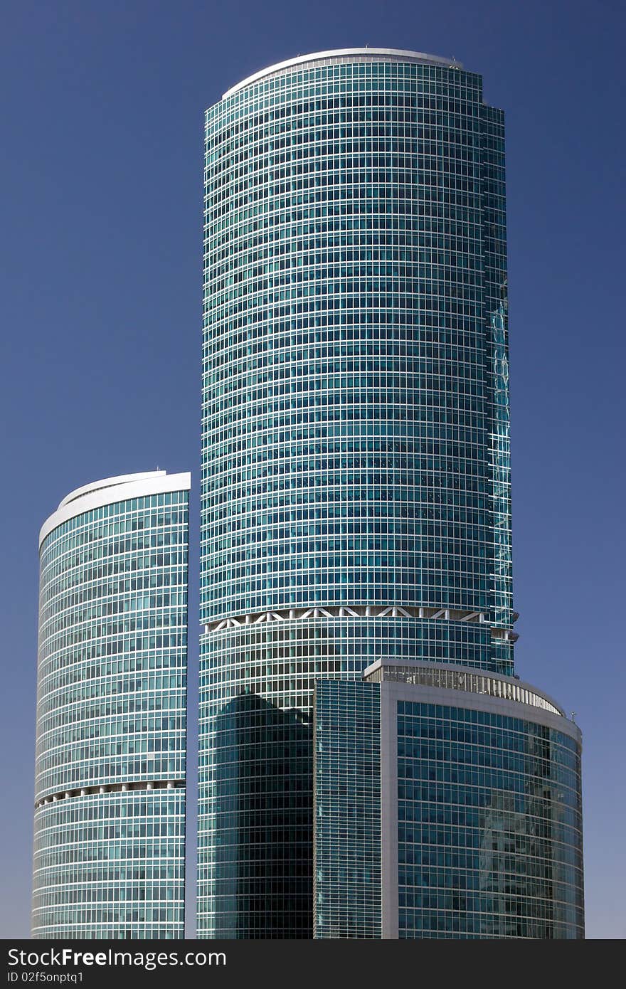 Blue modern office buildings over blue sky