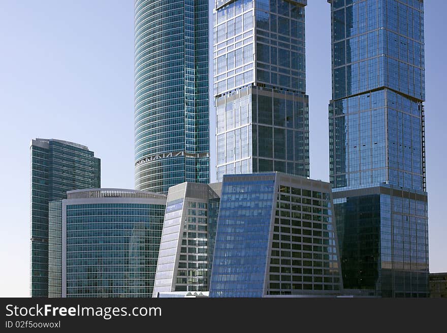 Blue modern office buildings over blue sky