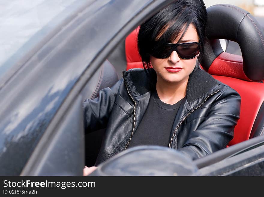 Young attractive woman in a black cabriolet. Young attractive woman in a black cabriolet.