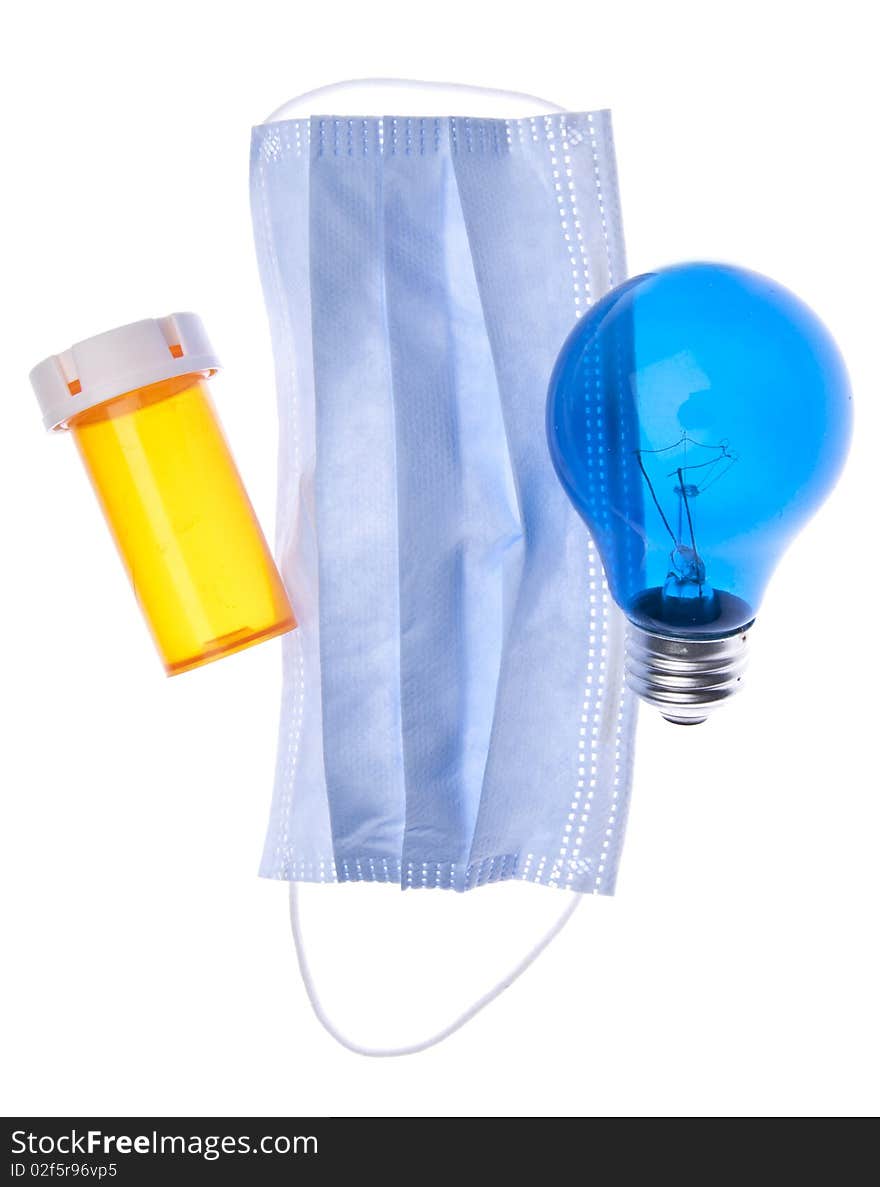 Prescription bottle, surgical mask and light bulb suggest ideas about health care and medicine. Prescription bottle, surgical mask and light bulb suggest ideas about health care and medicine.