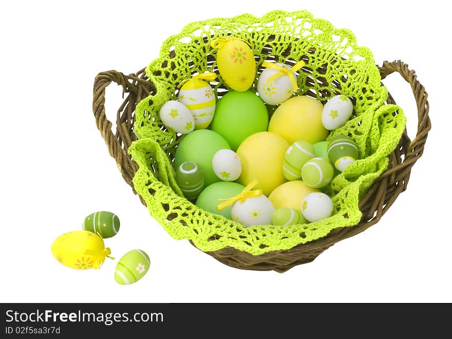 Colorful painted Easter eggs in the basket isolated on white background with clipping path