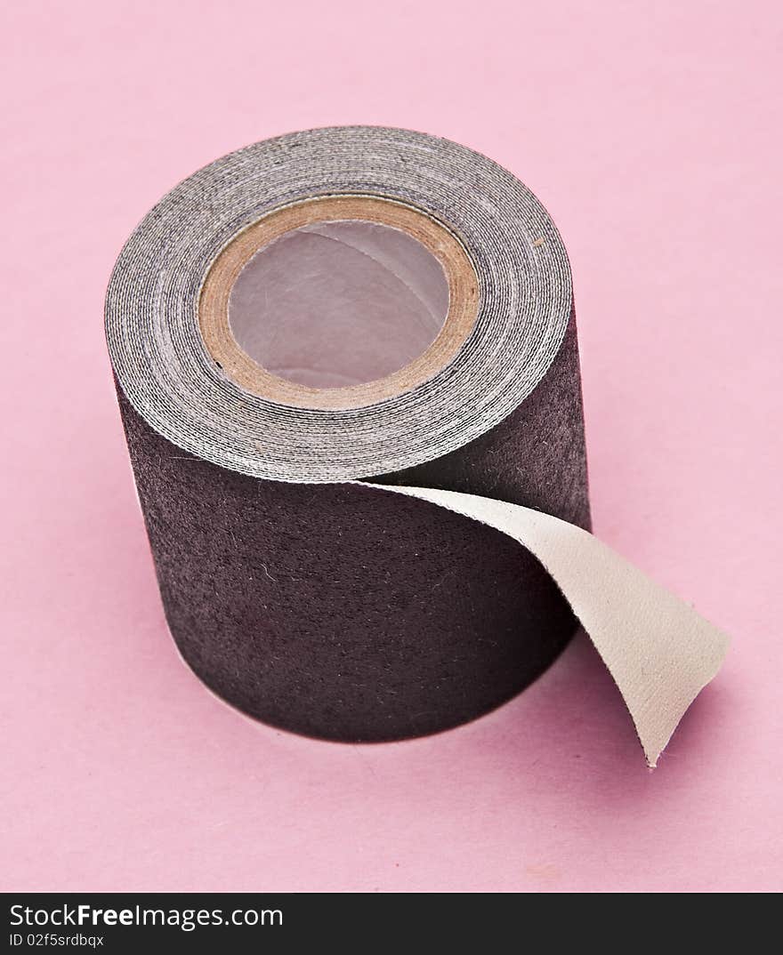 Black gaffers tape on a pink background. Black gaffers tape on a pink background.