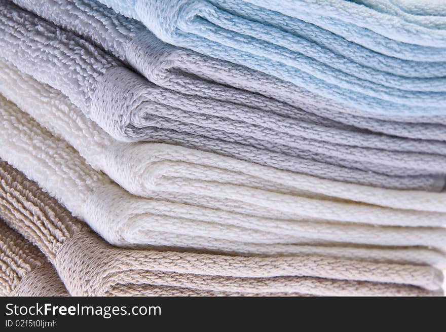 Neutral colored bath towels made of terry cloth.