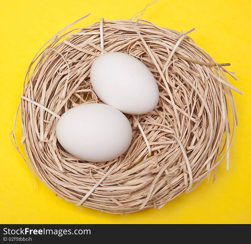 Eggs in a Nest on a Yellow Background.