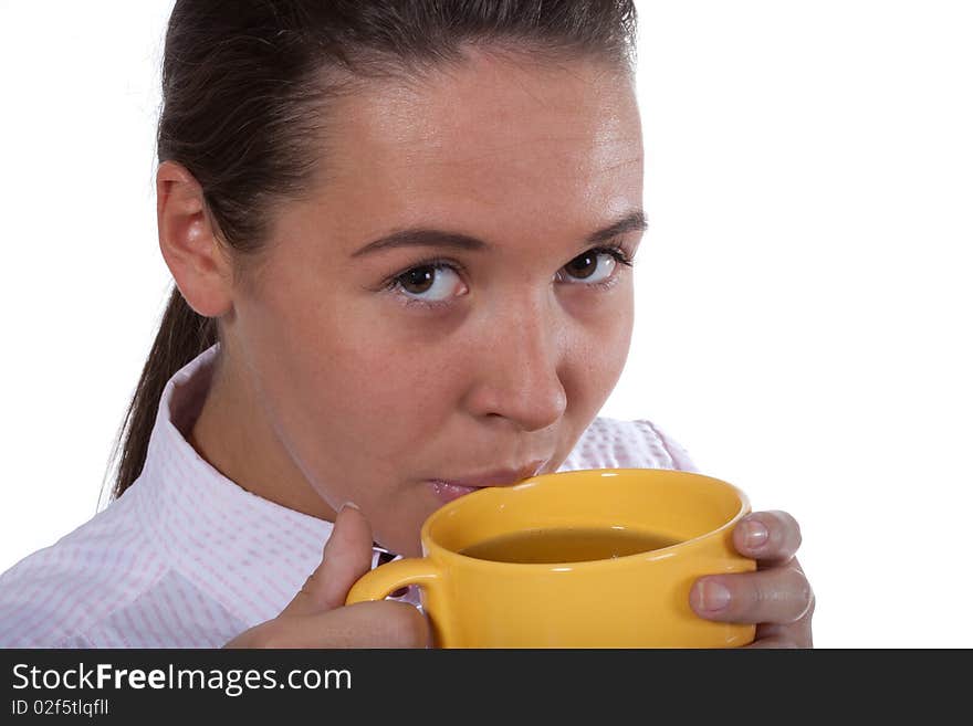 Young beautyful woman drink tea from big yellow cap. Young beautyful woman drink tea from big yellow cap