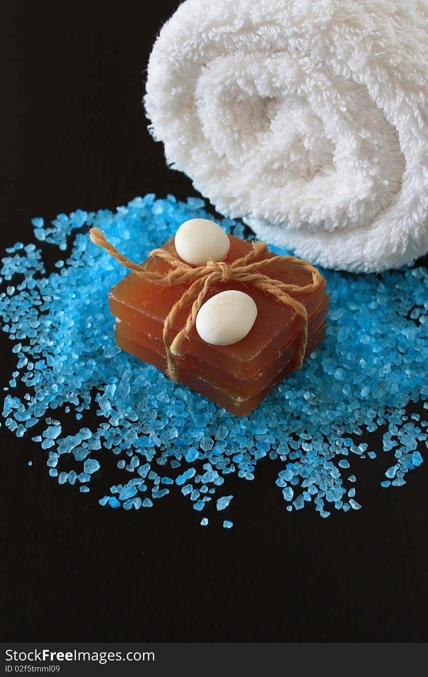 Spa concept. Sea salt on dark wooden  background.