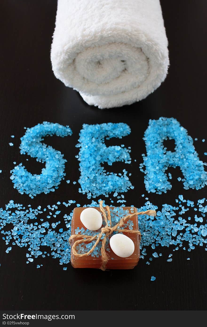 Spa concept. Sea salt on dark background.