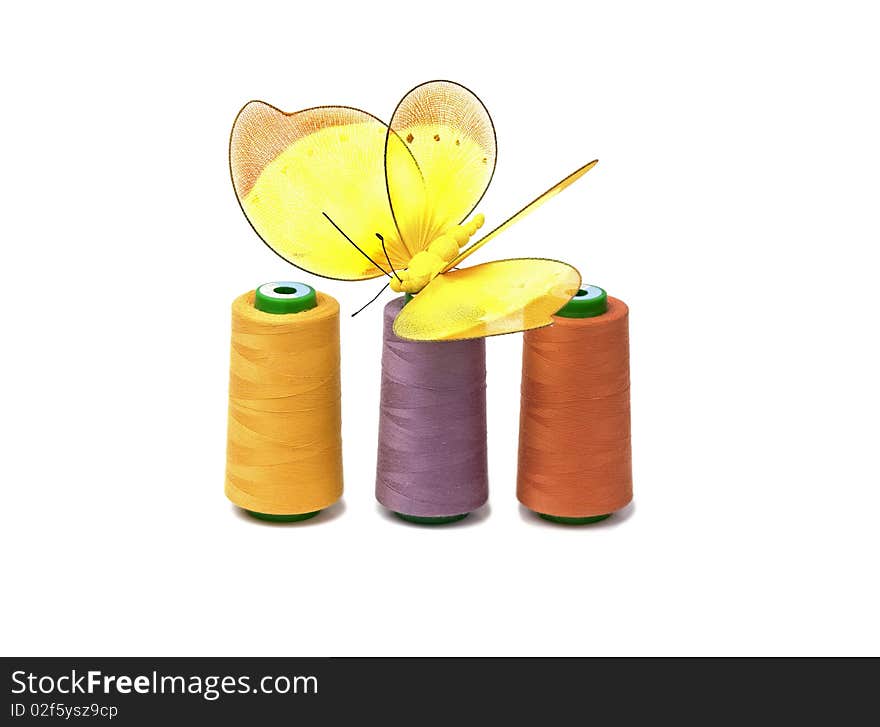 Coloreds spools with butterfly isolated on white background