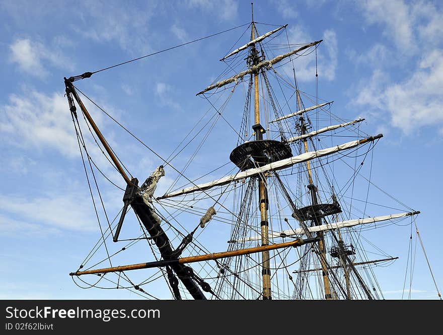 Landscape view of tall ship rigging against blue cloudy sky