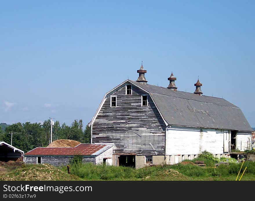 Big barn with three spinners with vents on top. Big barn with three spinners with vents on top