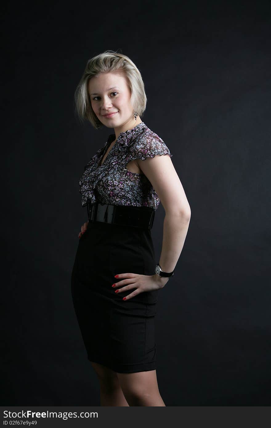 Portrait of the beautiful, young girl-blonde in a black-and-white dress. Portrait of the beautiful, young girl-blonde in a black-and-white dress