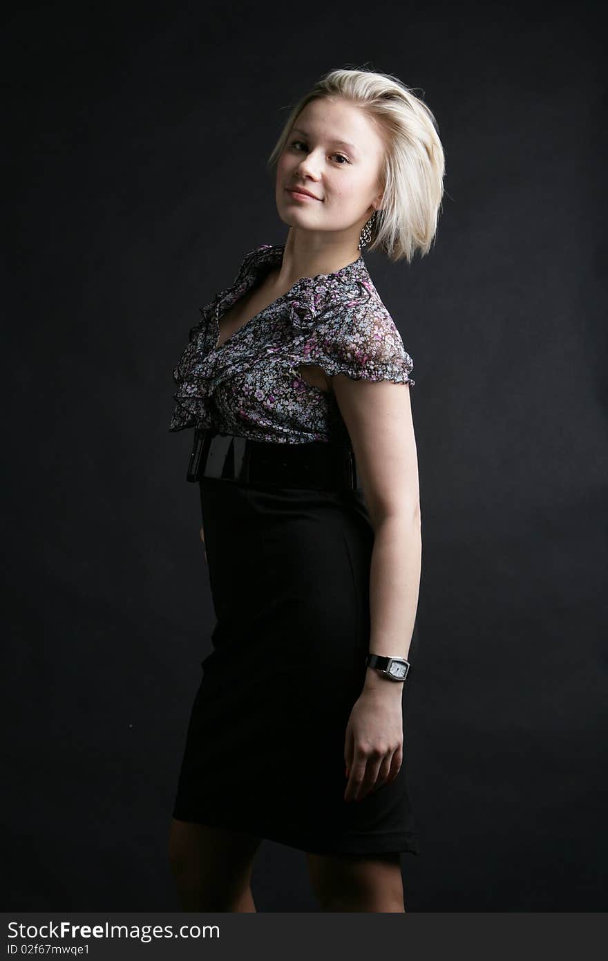 Portrait of the beautiful, young girl-blonde in a black-and-white dress. Portrait of the beautiful, young girl-blonde in a black-and-white dress