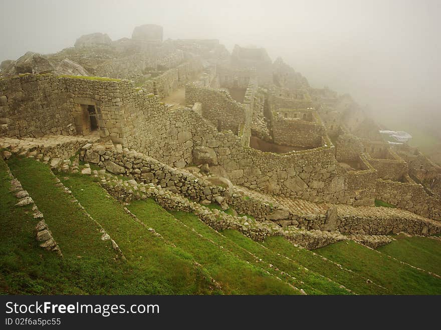 The world wonder of Machu Picchu coming out of the morning mist. The world wonder of Machu Picchu coming out of the morning mist.