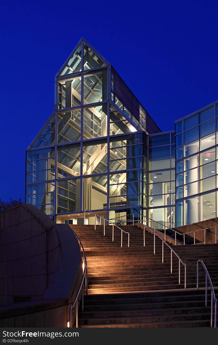 A night shot of a modern glass, and steel building. A night shot of a modern glass, and steel building.