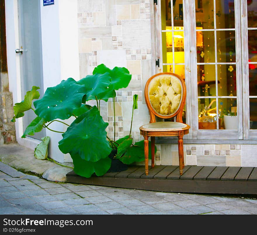 The chair of a retro stands in the street under a window. The ex-terrier