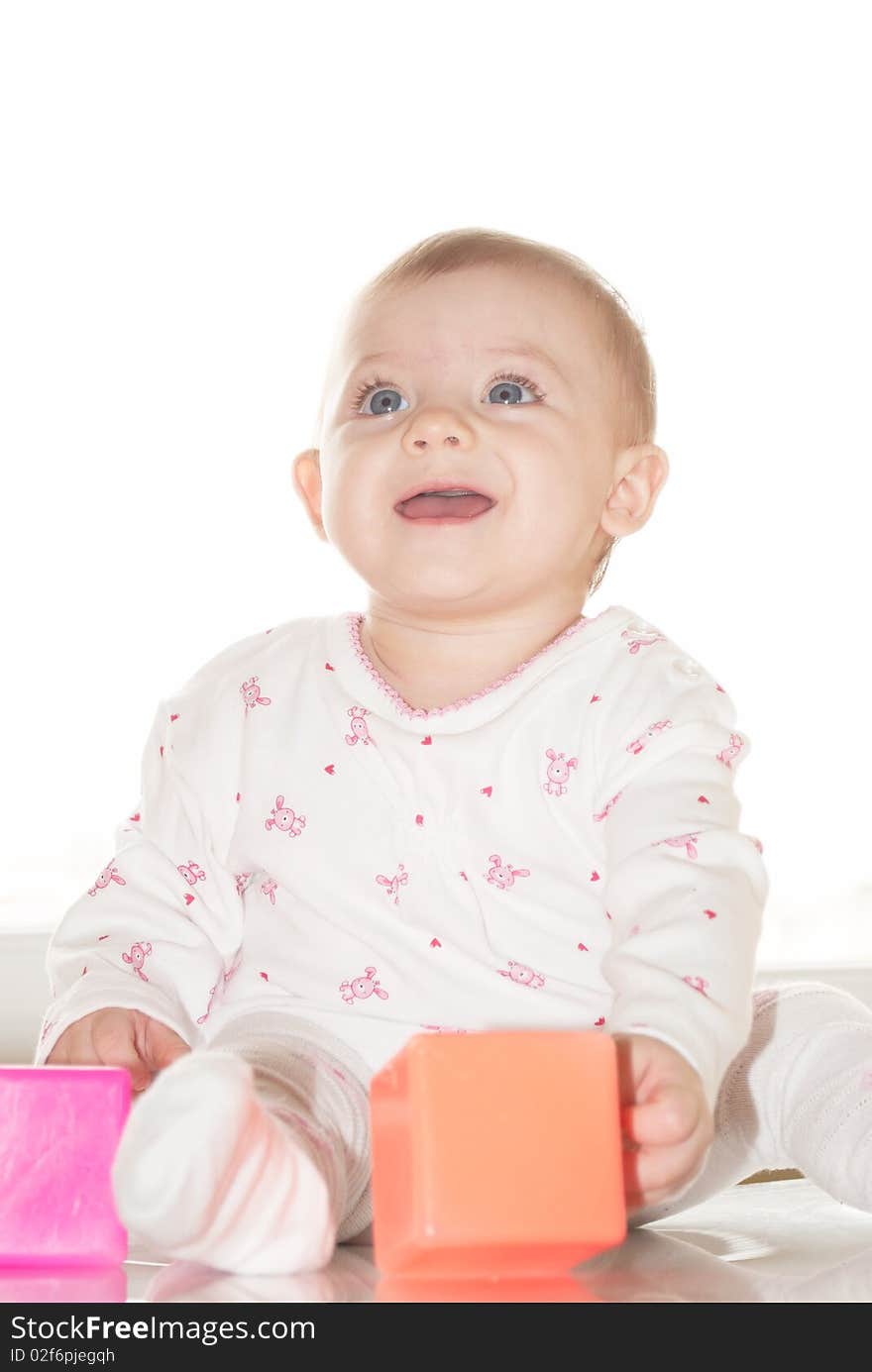 Portrait of the newborn child with a toy in a hand. Portrait of the newborn child with a toy in a hand