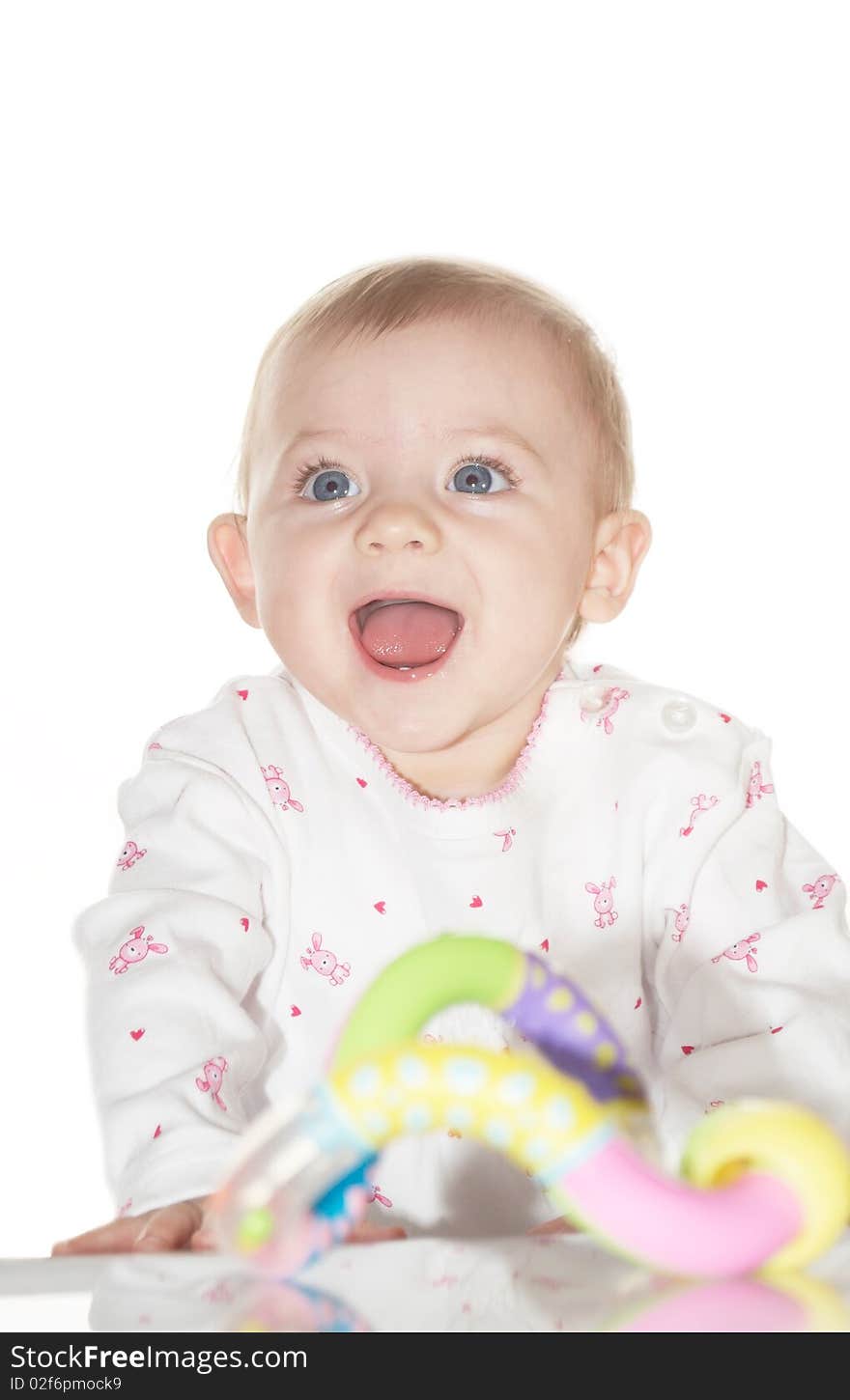 Portrait of the newborn child with a toy in a hand. Portrait of the newborn child with a toy in a hand