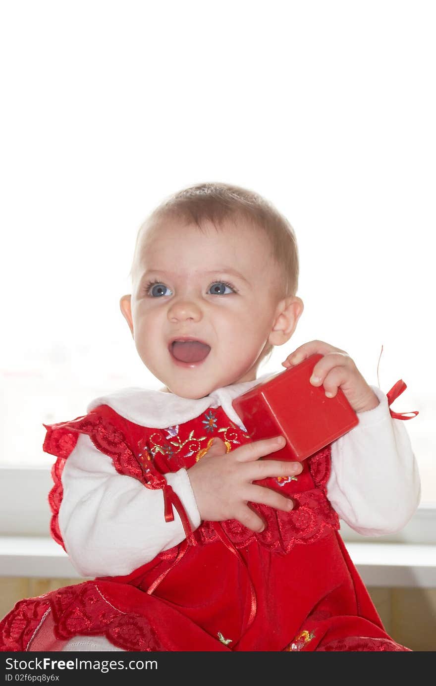 The child the girl in a beautiful dress on a background. The child the girl in a beautiful dress on a background