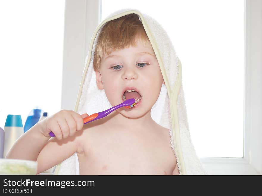 The little boy cleans a teeth on background. The little boy cleans a teeth on background