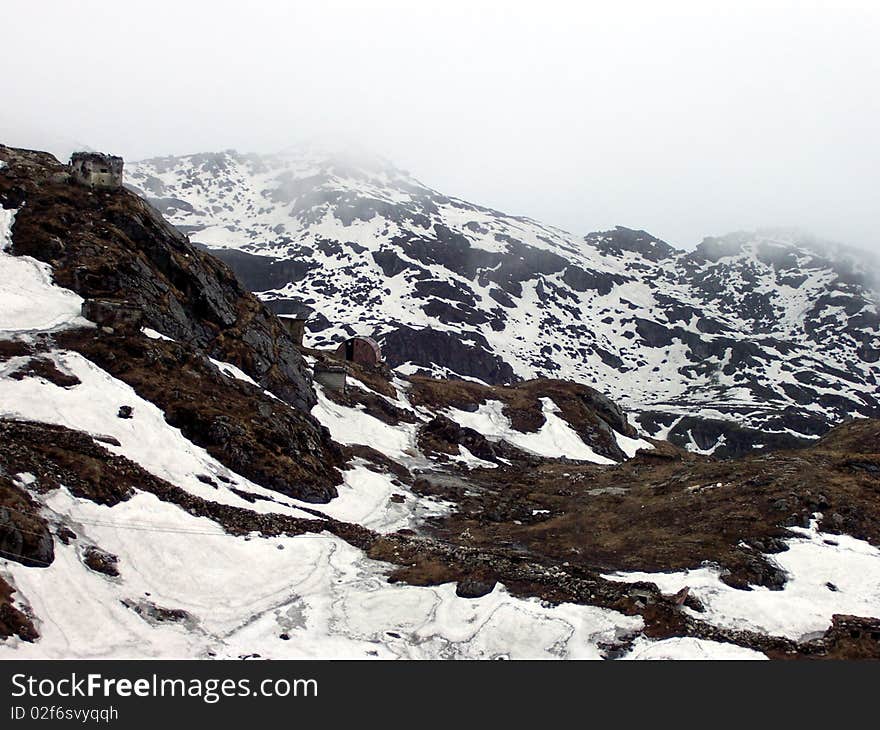 Snowfall over rocky mountains