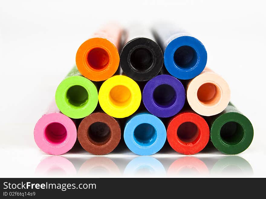 Colored crayons  on white background with reflection. Colored crayons  on white background with reflection