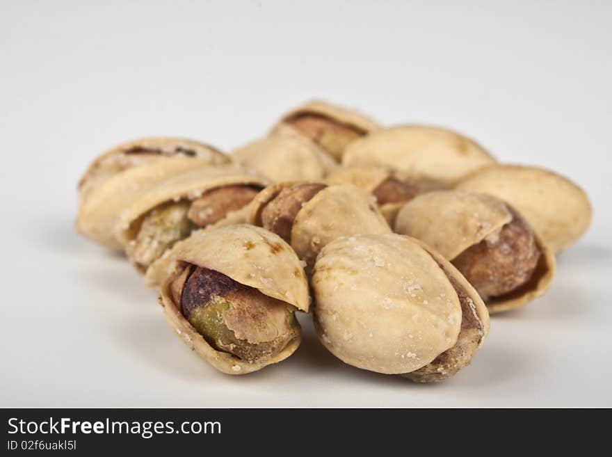 Fresh roasted pistatio closeup on white background. Fresh roasted pistatio closeup on white background