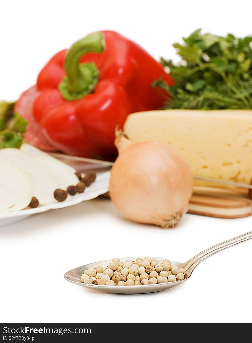 Spices on a spoon against vegetables