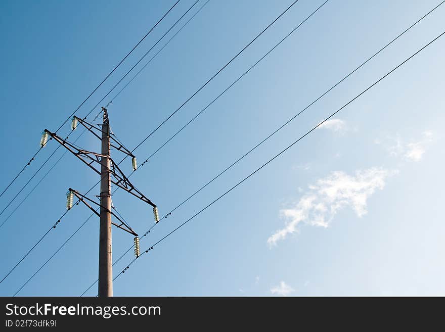 High voltage power supply line on a blue sky background. High voltage power supply line on a blue sky background