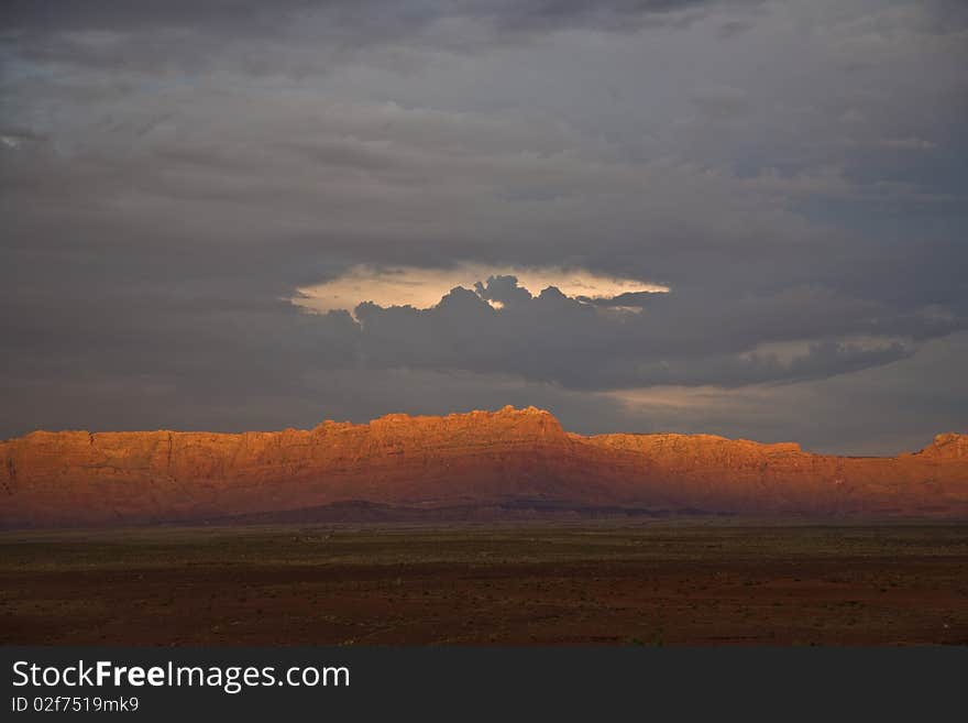 Echo Cliffs near Grand Canyon with dramatical sky and formations of clouds which show a face by using fantasy. Echo Cliffs near Grand Canyon with dramatical sky and formations of clouds which show a face by using fantasy