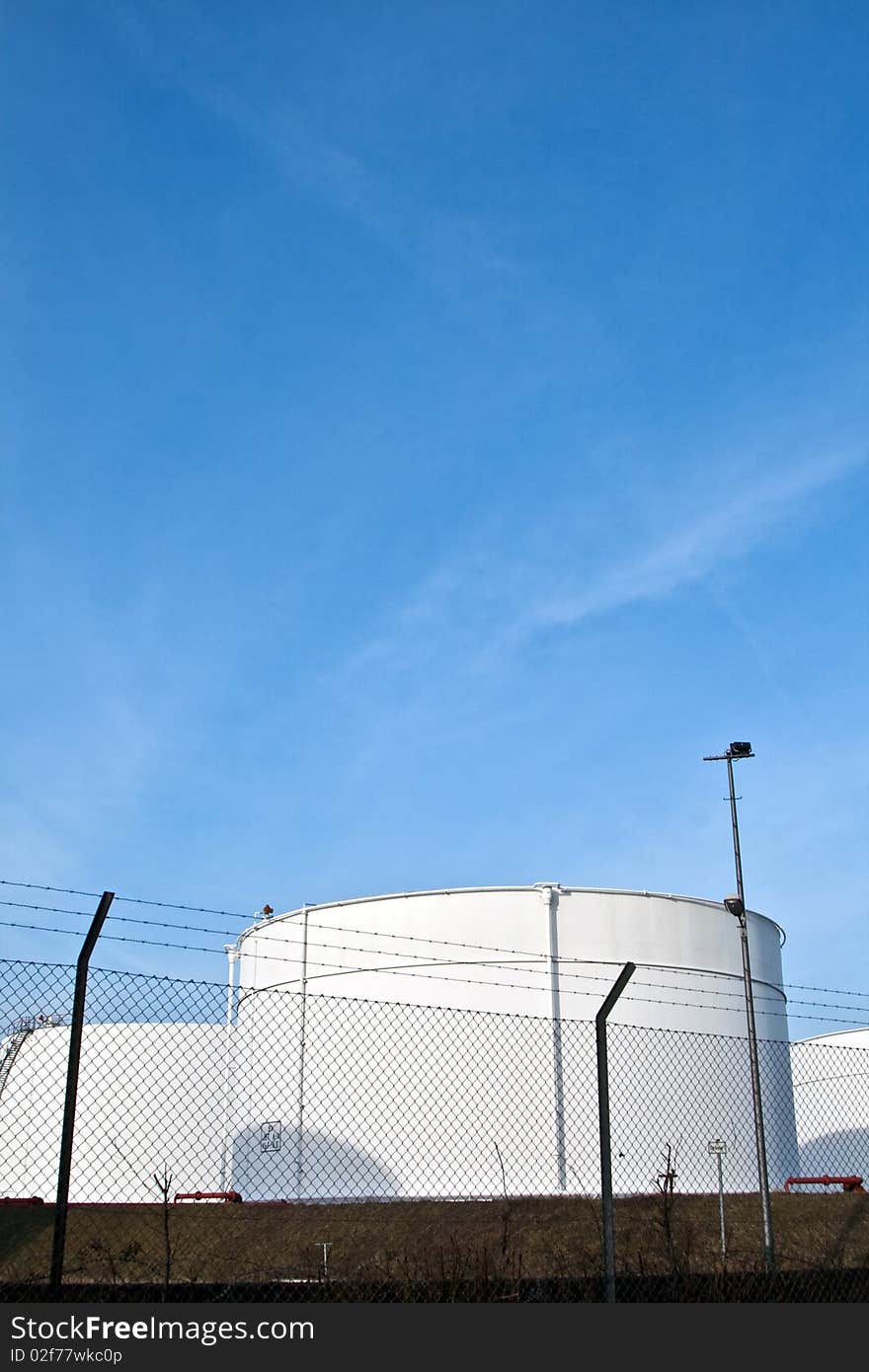 White tanks in tank farm with blue sky