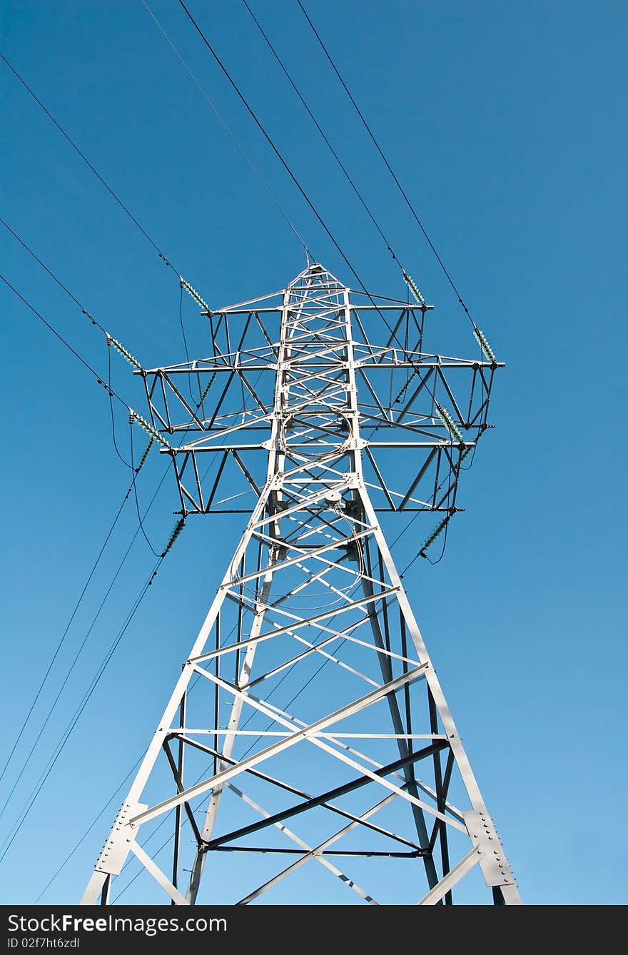 High voltage power supply line on a blue sky background. High voltage power supply line on a blue sky background