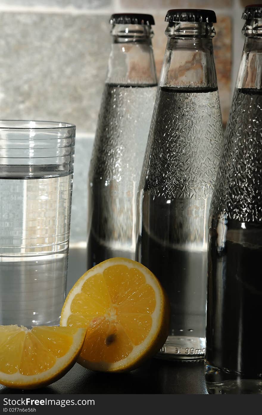 Bottle with mineral water and a lemon