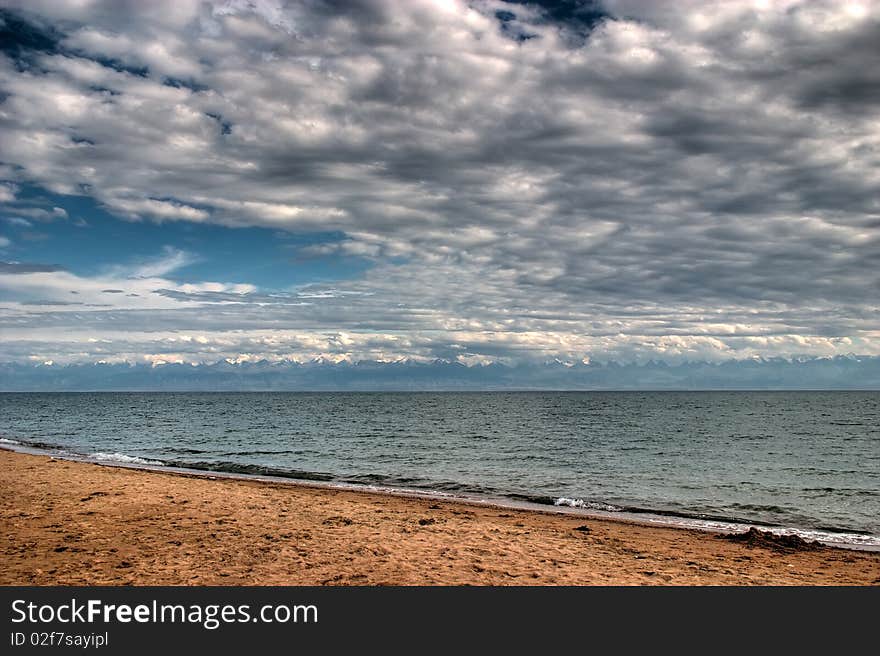 View from the peninsula Dolynka the southern shore of Lake Issyk-Kul. View from the peninsula Dolynka the southern shore of Lake Issyk-Kul