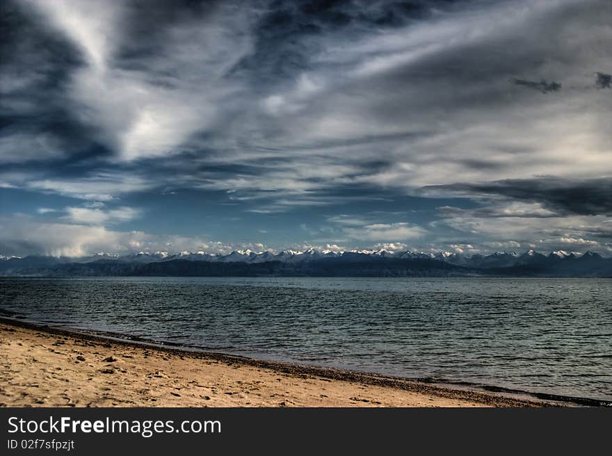 View from the peninsula Dolynka the southern shore of Lake Issyk-Kul. View from the peninsula Dolynka the southern shore of Lake Issyk-Kul