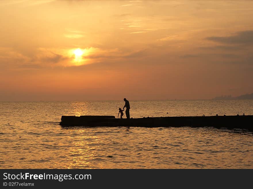 Father and child on the beach. Summer holidays at the Black sea. Father and child on the beach. Summer holidays at the Black sea.