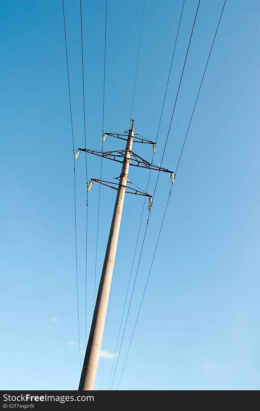 High voltage power supply line on a blue sky background. High voltage power supply line on a blue sky background